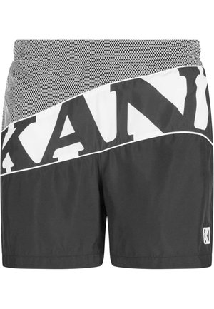 Schwarze Sportshorts mit einem Netzbund, ausgestattet mit weißen diagonalen Markenlogos. Hergestellt aus leichtem Material mit einer glatten Textur und gesteppten Details.