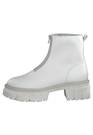 White leather ankle boots with a zip closure, chunky grey outsole, textured side details, and smooth upper surface.