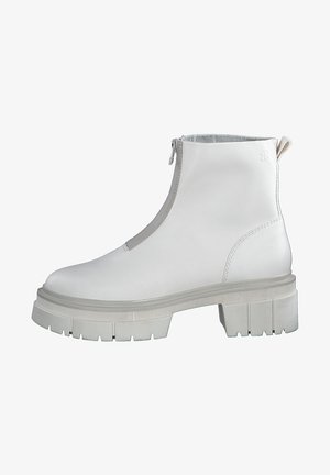 White leather ankle boots with a zip closure, chunky grey outsole, textured side details, and smooth upper surface.