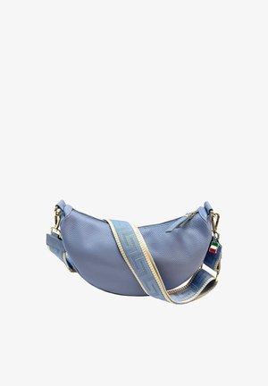 Light blue crescent-shaped leather crossbody bag with wide blue and beige adjustable strap, gold hardware, and small Italian flag tag.
