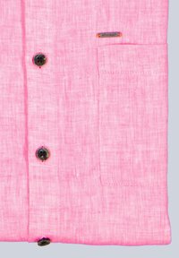 Helles rosa Leinenhemd mit einer Tasche, schwarzen Knöpfen und einem kleinen metallischen Markenschild mit orangefarbenen Akzenten. Glatte Textur, lässiges Design.