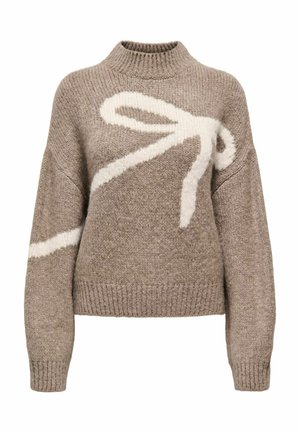 Light brown sweater made of knitted fabric, featuring a large white bow design across the front, ribbed neckline, and cuffs.