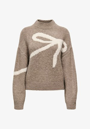 Light brown sweater made of knitted fabric, featuring a large white bow design across the front, ribbed neckline, and cuffs.