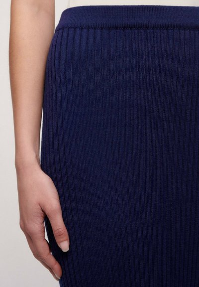Navy ribbed knit skirt with a solid texture and a fitted waistline. The design features vertical ribbing for added detail.