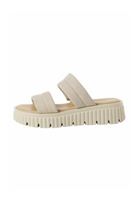 Beige slidesandal med två breda remmar, formad fotbädd och tjock räfflad sula. Materialet ser mjukt ut och har en slät yta.
