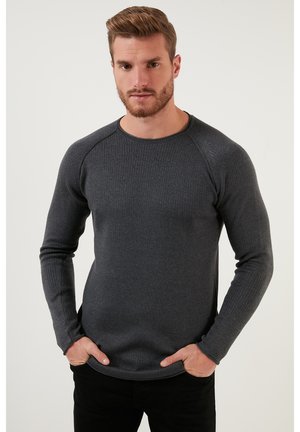 Dark gray long-sleeve ribbed shirt with a round neck and raglan sleeves, made from a textured fabric, fits snugly around the torso.