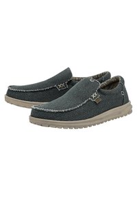 Scarpe slip-on grigie realizzate in tessuto texturizzato, con un design a cucitura contrastante, una morbida fodera interna e una suola flessibile beige.