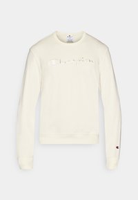 Sweat-shirt à manches longues de couleur crème avec logo "Champion" brodé sur la poitrine et petit logo Champion sur le poignet de la manche gauche.