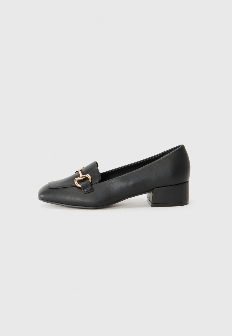 Black leather loafers with a flat heel, featuring a decorative gold hardware detail on the front and a smooth texture.