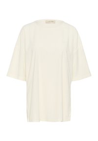 Krämfärgad oversized t-shirt i bomull med rund halsringning, korta ärmar och en mjuk textur. Har en logomarkering vid halsringningen.