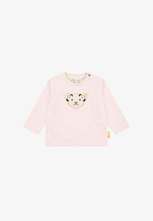 Helles, pinkes Langarmshirt mit Rundhalsausschnitt, das in der Mitte ein weiches, gesticktes Design eines Löwenkopfes zeigt und ein gelbes Etikett an der Seite hat.