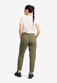 Olive green outdoor pants with adjustable cuffs, elastic waist, and side pockets. Paired with a neutral-colored short-sleeve top.