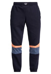 Mörkblå sweats med elastisk midja, orange och blå nätpaneler samt smalnande manchetter. Har logotypdetalj på midjan.