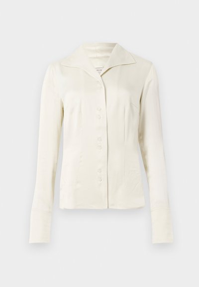 Off-white long-sleeve button-up blouse with wide collar and fitted waist, displayed against a plain light background.