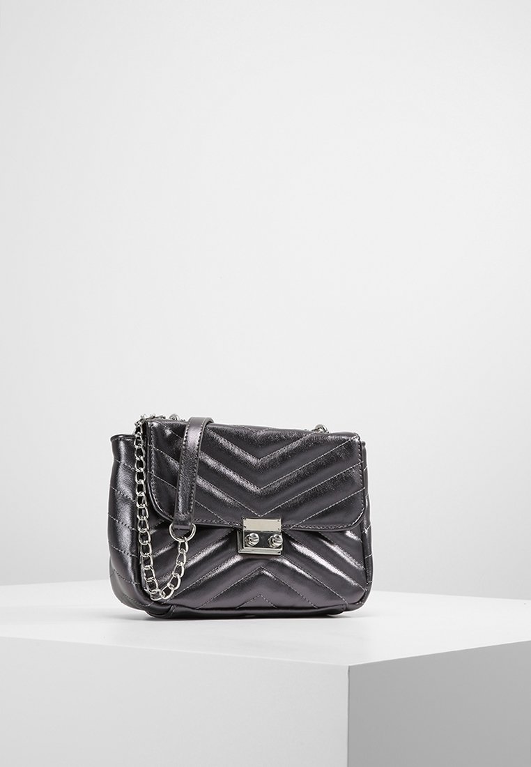 Borsa a tracolla grigia metallica con motivo a zig zag, hardware argento e tracolla a catena. Caratterizzata da una chiusura frontale a gancio.