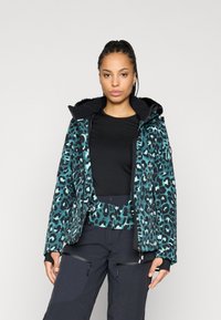 Ζακέτα με σχέδιο λεοπάρ σε τυρκουάζ και μαύρο, με επένδυση από γούνα στην κουκούλα. Διαθέτει φερμουάρ και μαύρη μακρυμάνικη μπλούζα από μέσα.