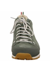 Green suede sneaker with white laces, rubber sole, and contrasting tan outsole. Features a small Italian flag accent on the back.