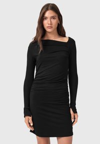 Abito lungo nero a maniche lunghe con scollatura quadrata, texture arricciata e silhouette aderente. Realizzato in tessuto elasticizzato per il massimo comfort.