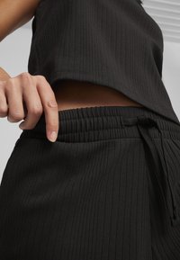 Puma Pantaloni sportivi - black