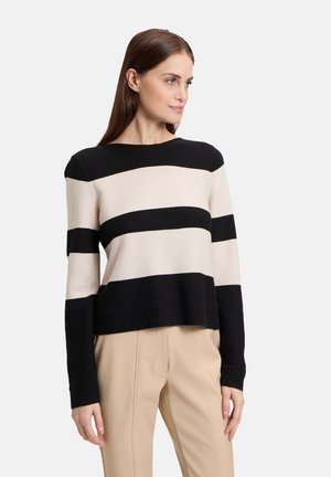Black and beige striped sweater with long sleeves, round neckline, and a relaxed fit. The texture appears smooth and knit.