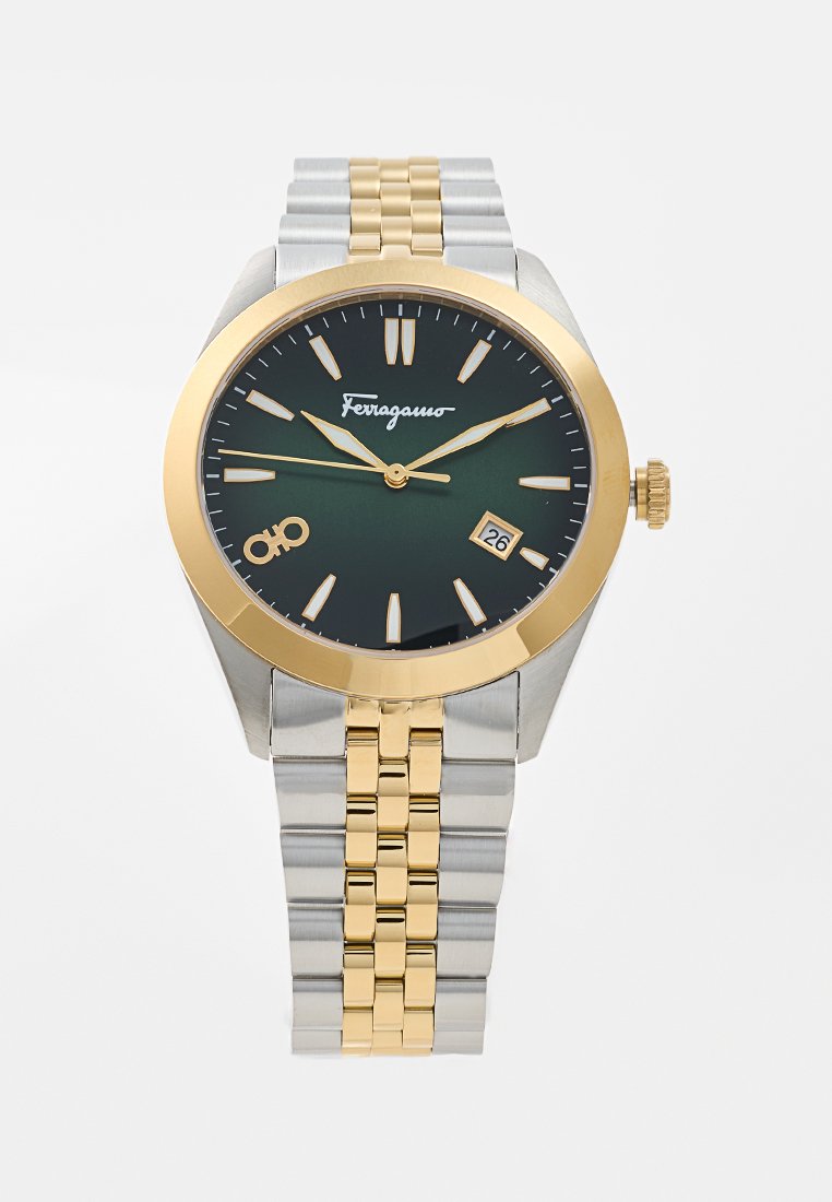 Montre pour homme avec un cadran vert, une lunette dorée, un bracelet en acier inoxydable argenté et doré, un affichage de la date, et des index horaires lumineux.