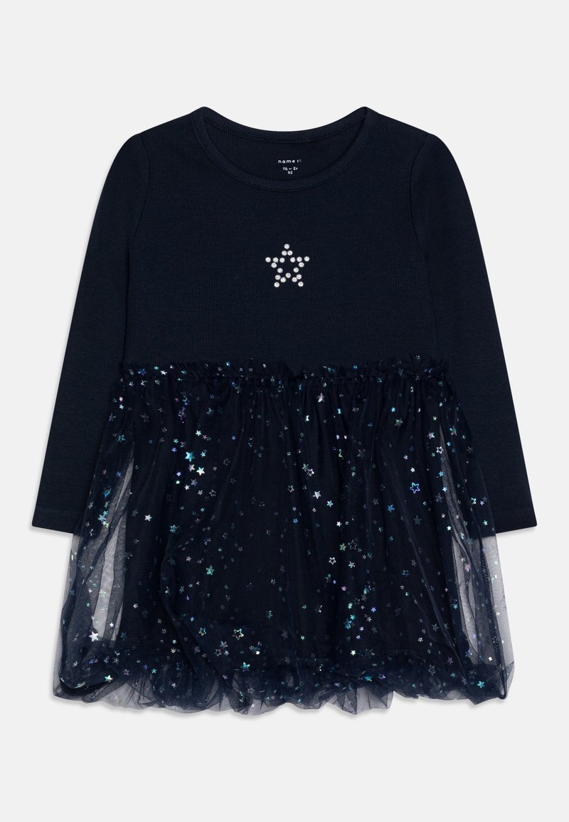 Robe pour tout-petit à manches longues bleu marine avec une étoile en strass sur la poitrine et une superposition de jupe décorée de motifs d'étoiles holographiques.