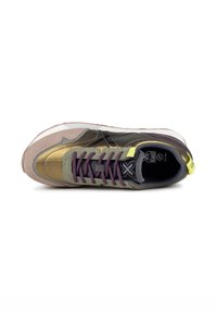 Sneakers rétro avec un mélange de matériaux, arborant des teintes de gris, vert olive et doré. Comprend des lacets violets et une étiquette de talon jaune vif.