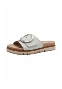 Slide sandal featuring a white leather upper, a large circular silver buckle, and a textured light brown platform sole.