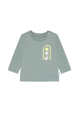 Light green long-sleeve shirt made of smooth cotton fabric. Features a round neckline and a yellow graphic print of a sun and text.