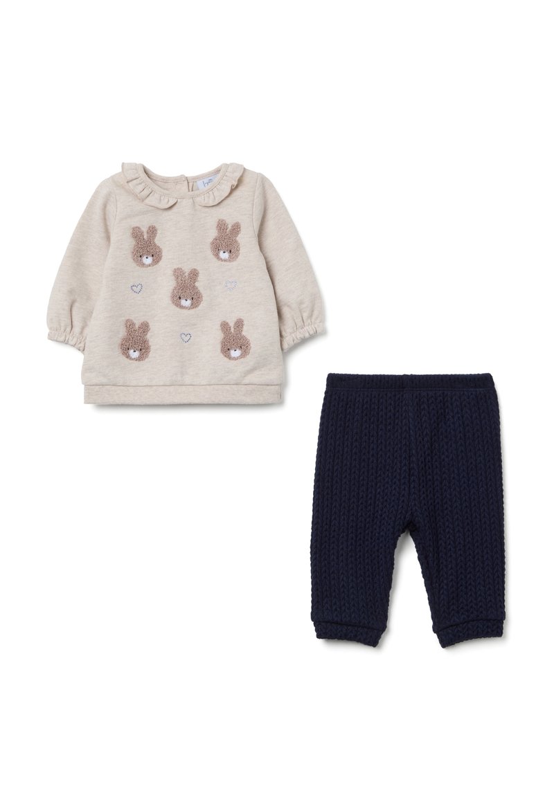 Beige sweatshirt met pofmouwen, voorzien van textuurrijke konijnapplicaties en harten. Marineblauwe ribgebreide broek met elastische tailleband.