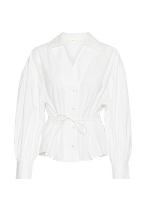 White shirt made of cotton with a fitted waist tie, button front, and long balloon sleeves. Features a classic collar and smooth texture.