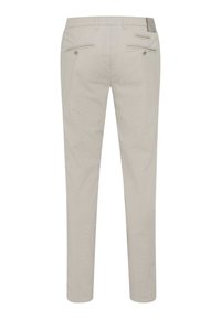 Pantalons beige clair au design slim-fit. Dotés de deux poches arrière avec fermetures à boutons et de détails de couture subtils. Texture lisse.