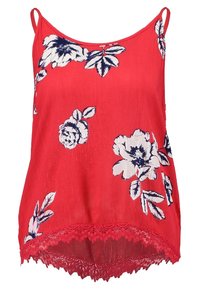 Top sin mangas rojo con patrón floral en blanco y marino. Cuenta con un dobladillo de encaje y tirantes finos ajustables. Está hecho de una tela ligera.