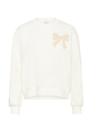Sweatshirt blanc avec un col rond et des manches longues, arborant une broderie de nœud crème sur le côté gauche de la poitrine. Texture douce avec un ourlet côtelé.