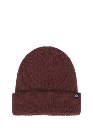 Knitted dark red beanie hat with folded cuff and small black tag featuring a white mountain wave logo on the cuff.