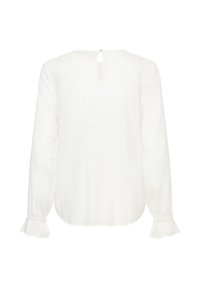 Blouse blanche à manches longues avec un dos en forme de clé, des poignets froncés et un tissu texturé. Ourlet droit sans motifs ni détails supplémentaires.