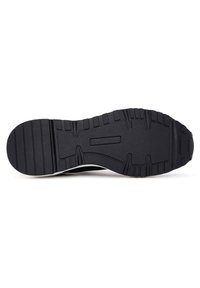 Black rubber shoe sole with textured tread pattern, including horizontal and angled grooves, on a white background.