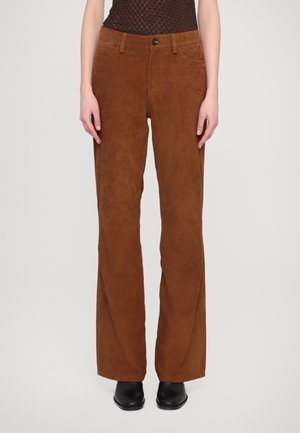 Brown suede flared pants with a high waist, front pockets, and a contrasting button closure. Smooth texture with a matte finish.