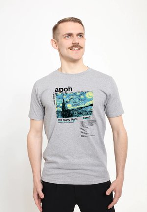T-shirt en coton gris avec un graphique de "La Nuit étoilée" de Van Gogh, avec des accents de texte noir. Manches courtes et encolure ras du cou.