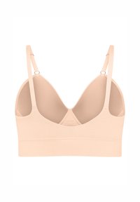Nude trådlös bh med justerbara axelremmar, mjukt tyg och en slät yta; har en U-formad rygg och minimala sömdetaljer.