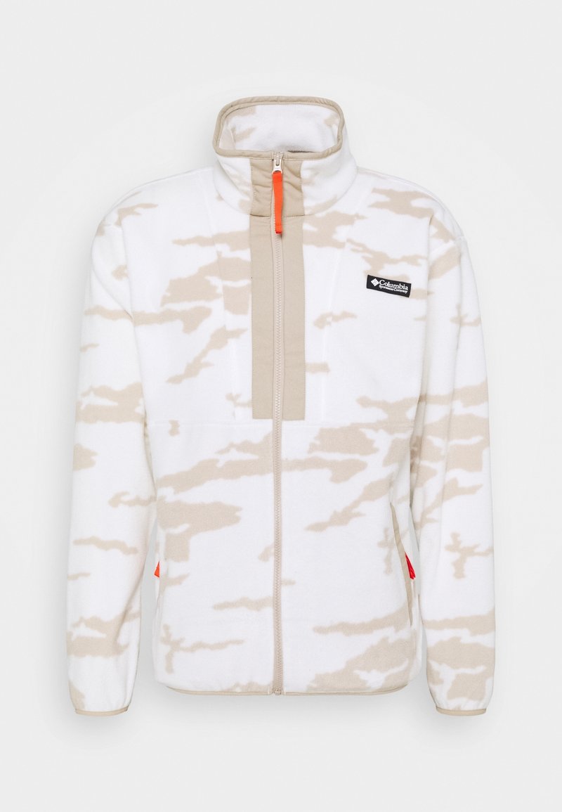 Veste en polaire blanche avec des motifs en forme de nu beige, fermeture éclair intégrale, col haut et tirette de fermeture éclair orange. Dispose d'une poche avant avec le logo de la marque.