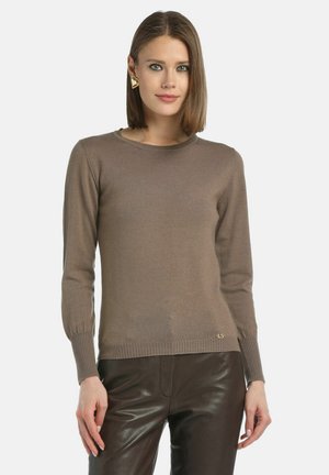Brown knitted sweater with long sleeves and a crew neck, paired with brown leather pants. Gold logo detail near the hem.