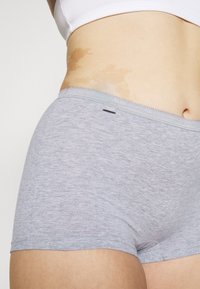 Grey cotton boyshorts with a smooth texture, featuring a waistband with a contrasting stitch and a small logo tag on the side.