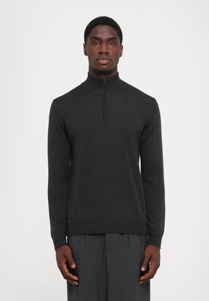 Dark gray sweater with a high collar, half-zip closure, and long sleeves. Made from a soft knit material, featuring a snug fit at the hem.