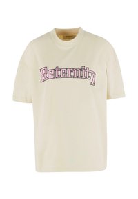 Kremfarget t-skjorte laget av bomull, med rund hals og korte ermer. Framsiden har rosa tekst som sier "Reternity."