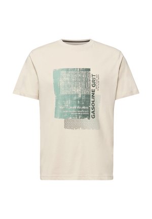 Beige lyhythihainen t-paita, jossa on kulunut sinivihreä ja valkoinen kuva, jossa on pystysuoria viivoja ja teksti "GASOLINE GRIT" ja "RIDE CULTURE".