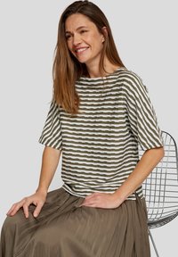 Khaki and white striped top with a relaxed fit, short sleeves, and a round neckline, paired with a flowing, pleated brown skirt.