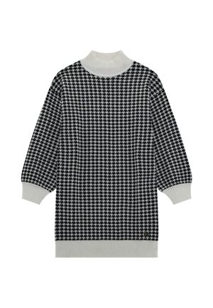 Juoda ir balta houndstooth rašto megztinis su aukštu ribotu apykakle ir plačiomis rankovėmis. Tekstūruota mezgimo medžiaga.