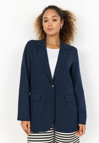 Námořnický blazer vyrobený z lehkého materiálu, s jedním knoflíkem, výstřihy s klopami, dvěma předními kapsami a dlouhými rukávy.