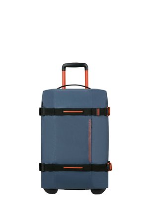 Blue fabric suitcase with an extendable orange handle, black straps, and a side pocket. Features sturdy wheels for easy mobility.